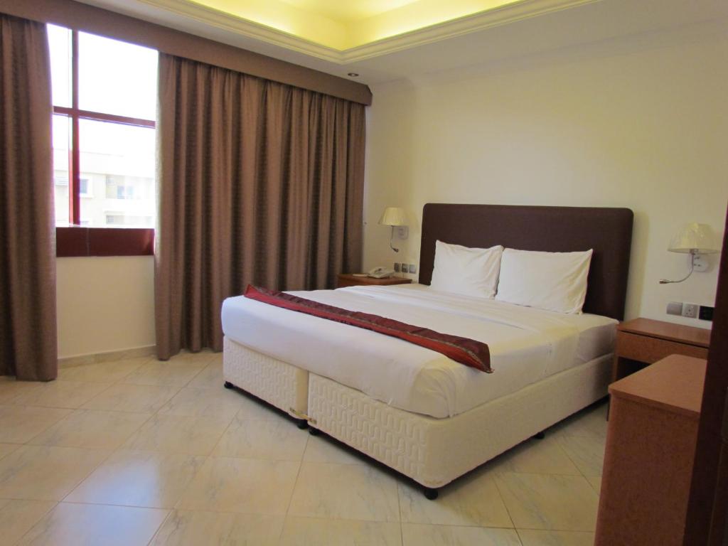 Postel nebo postele na pokoji v ubytování Mirage Hotel