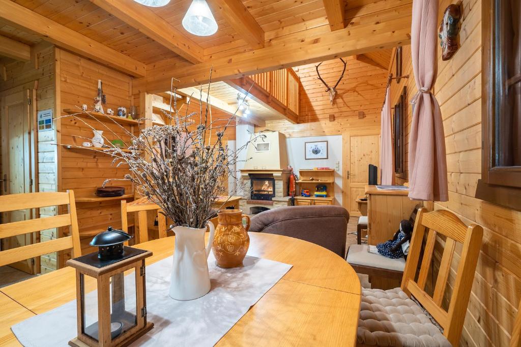 a kitchen and dining room with a table in a cabin at Wili Hunter in Donovaly