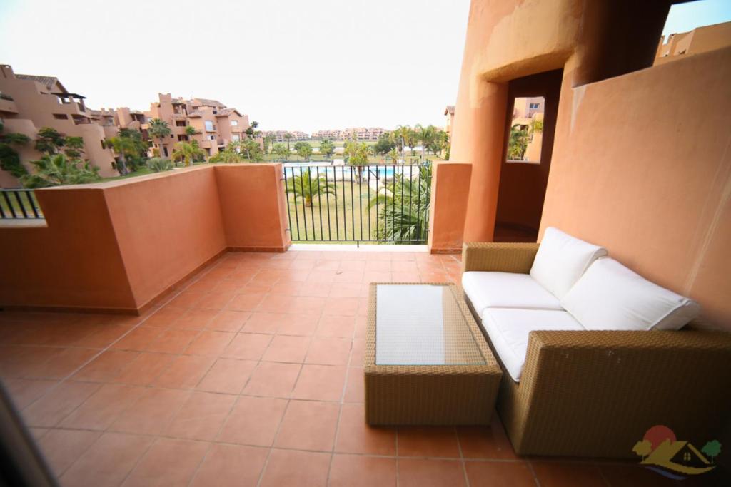 einen Balkon mit einem Sofa und Stadtblick in der Unterkunft Apartment - Sleeps 4 - Pool - Terrace - Parking in Torre-Pacheco
