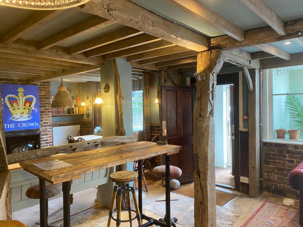 a dining room with a wooden table in a room at The Crown Inn Dial Post in Horsham