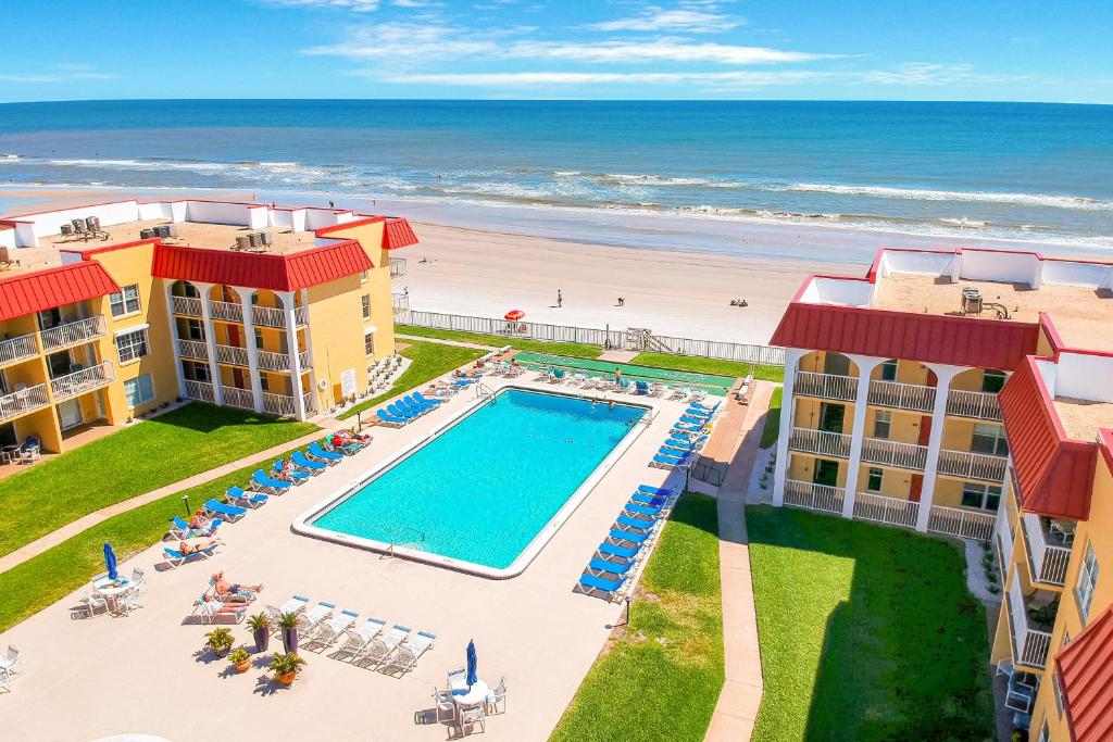 an aerial view of the pool and the beach at Point East in New Smyrna Beach