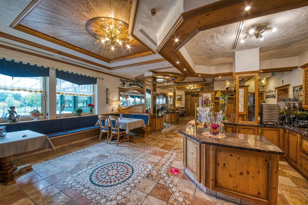 a large room with a kitchen and a table at Hotel Haus Tiefenbach in Bullange