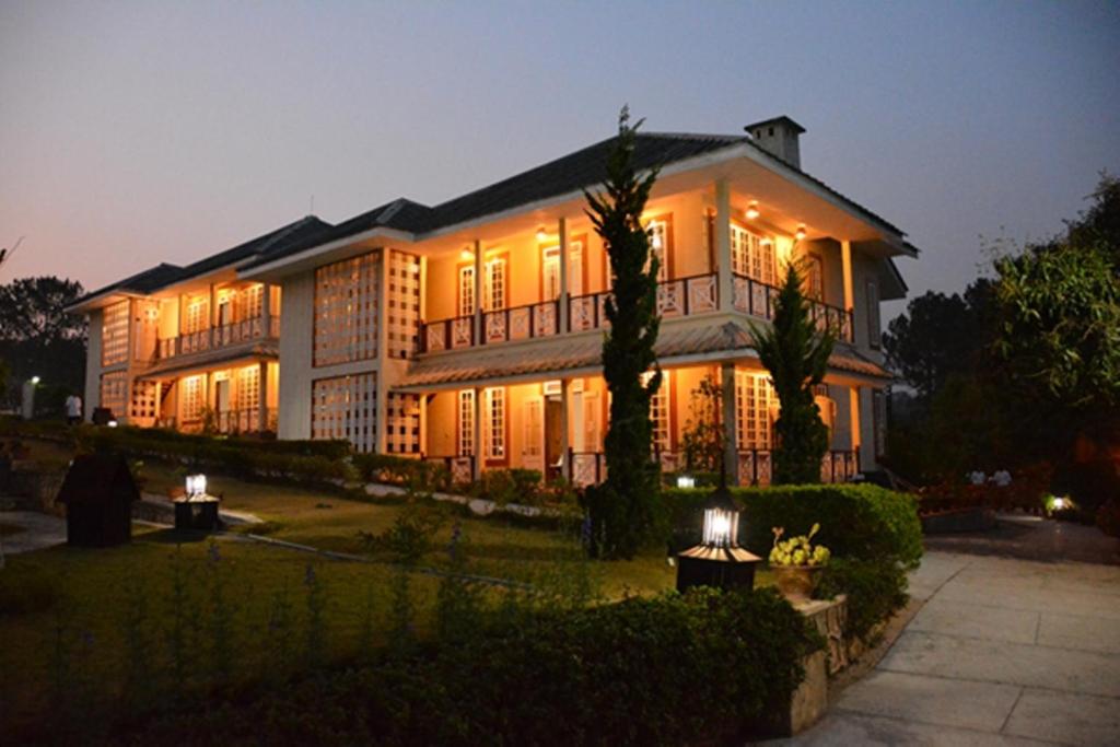 a large house with lights on it at night at Pine Hill Resort in Kalaw