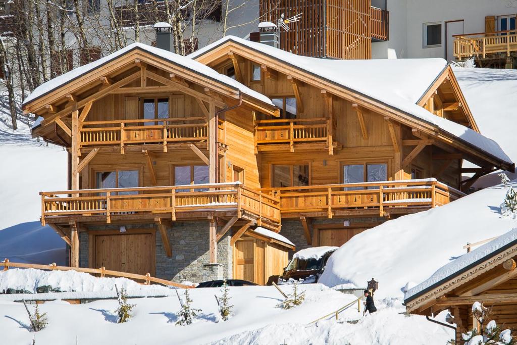 a log cabin in the snow with snow at Chalet l'ALPAGA 2 in Les Deux Alpes