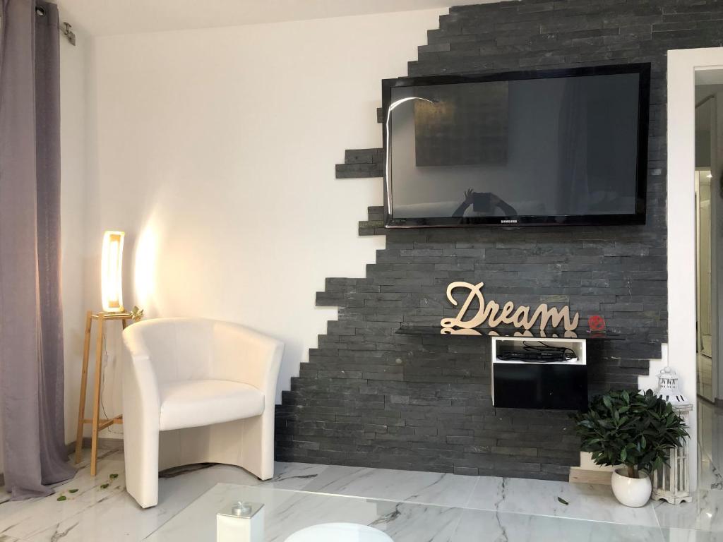 a living room with a tv on a brick fireplace at Fabulous Lakeside Family Apartment | 4 Rooms in Montreux