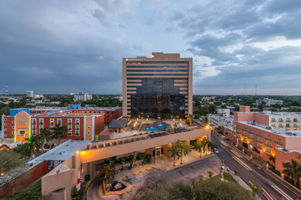 an aerial view of a city with a tall building at Hyatt Regency Merida in Mérida