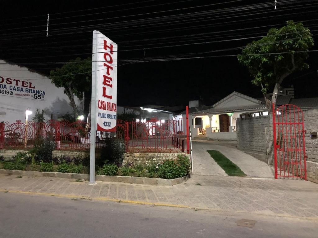 a sign on the side of a street at night at Hotel Casa Branca in Garanhuns