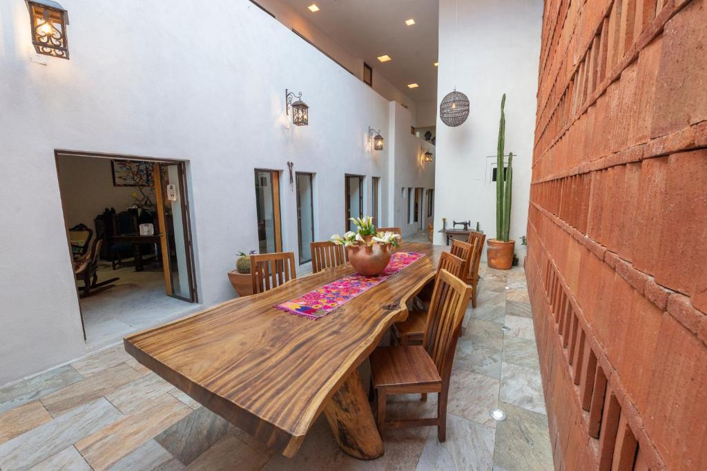 a dining room with a wooden table and chairs at La Casa Carlota in Oaxaca City