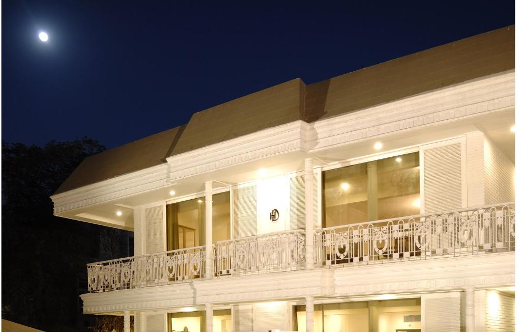 a large white building with a balcony at night at Diplomat, Chanakyapuri New Delhi- A Boutique Hotel in New Delhi