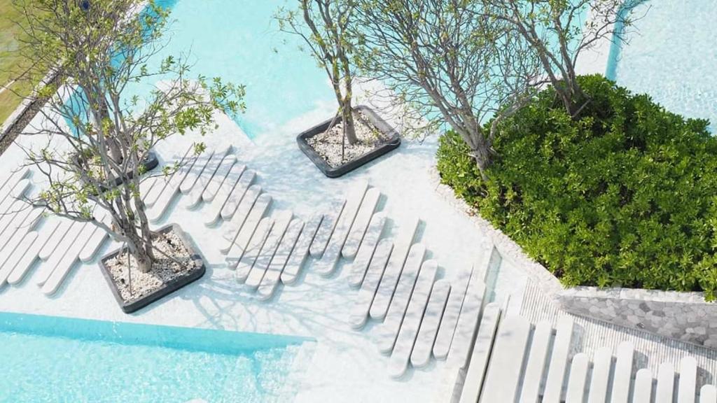 a rendering of three trees and a white fence at Veranda Residence Pattaya By Fon in Na Jomtien