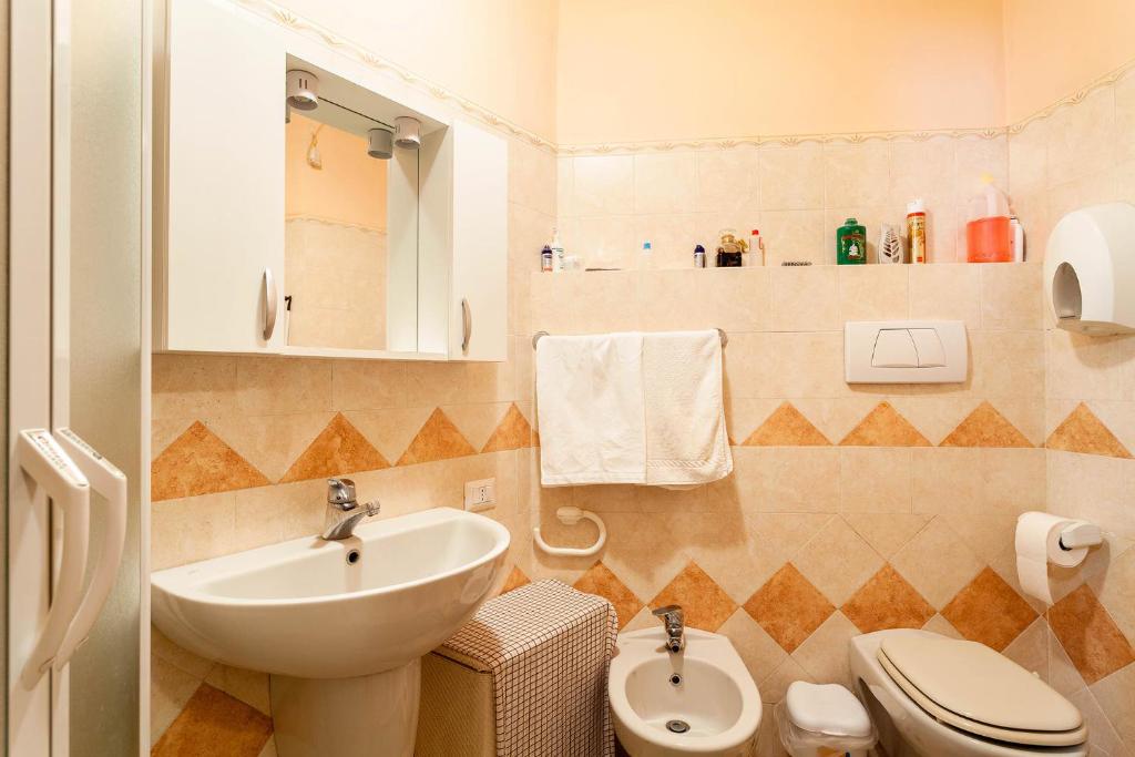 a bathroom with a sink and a toilet at Casa Nicolò in Massa Lubrense