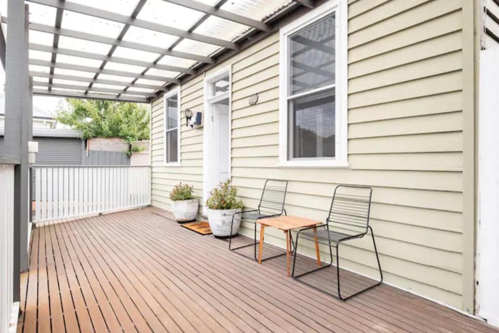 a patio with two chairs and a table on a house at Quartz Cottage Geelong in Geelong