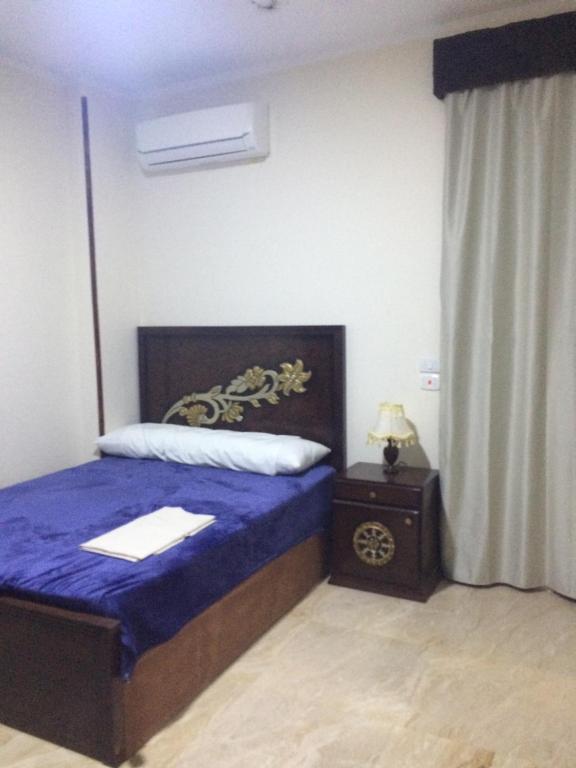 Postel nebo postele na pokoji v ubytování Lady Queen Apartment