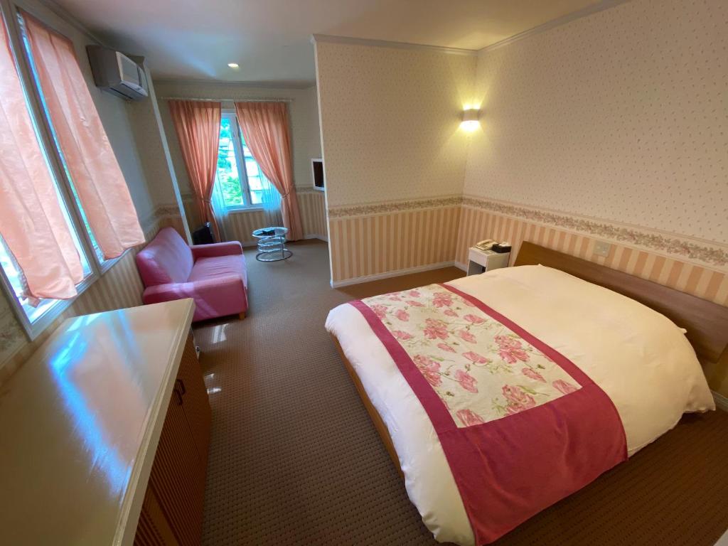 Postel nebo postele na pokoji v ubytování Auberge Mermaid