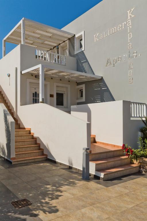 a house with a staircase in front of it at Kalimera Karpathos Exclusive Villas in Afiartis