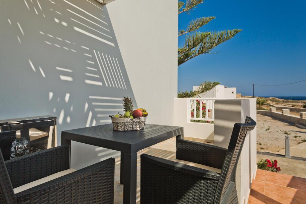 a black table and chairs on a patio at Kalimera Karpathos Exclusive Villas in Afiartis