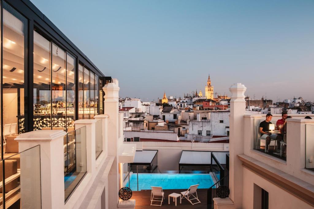a balcony with a view of a city at Hotel Unuk in Seville