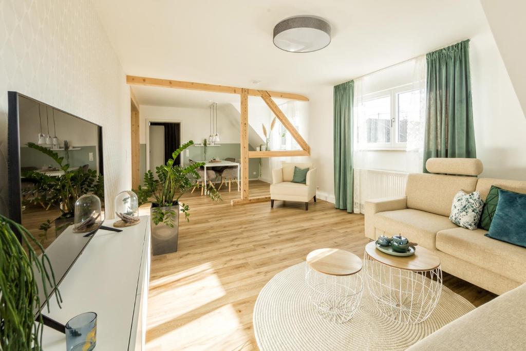 a living room with a couch and a table at Ferienwohnung Albblick in Holzmaden