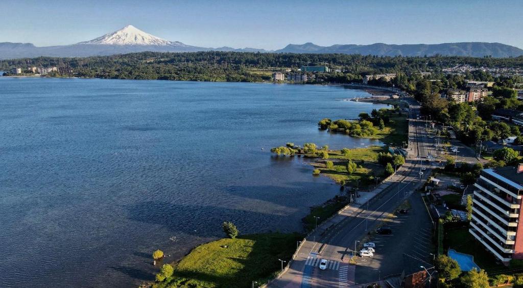 an aerial view of a lake with a mountain in the background at Hotel Costanera in Villarrica