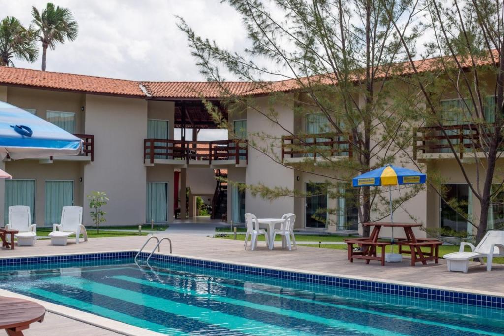 a villa with a swimming pool and a resort at Portal do Sol Lençóis Pousada in Barreirinhas