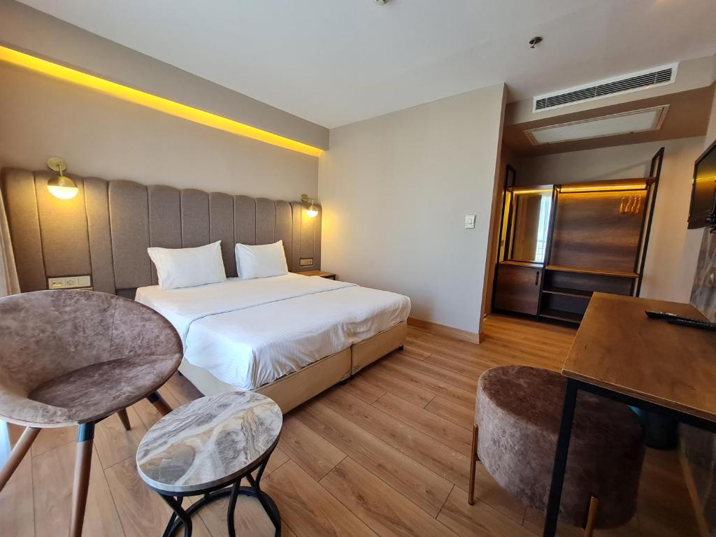 a hotel room with a bed and a desk at Air Boss Istanbul Airport and Fair Hotel in Istanbul
