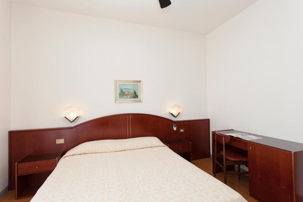 Postel nebo postele na pokoji v ubytování Hotel Arborea