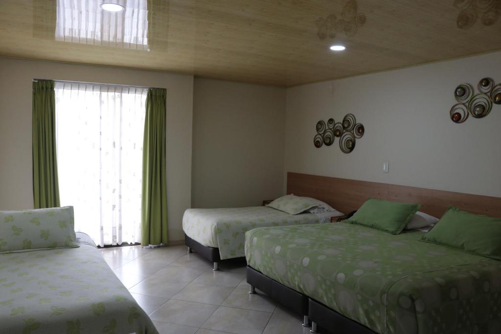 Postel nebo postele na pokoji v ubytování Hoteles Bogotá Inn Park Way