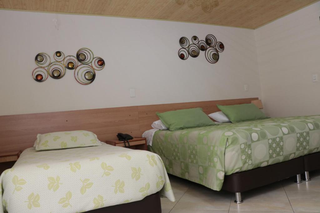 Postel nebo postele na pokoji v ubytování Hoteles Bogotá Inn Park Way