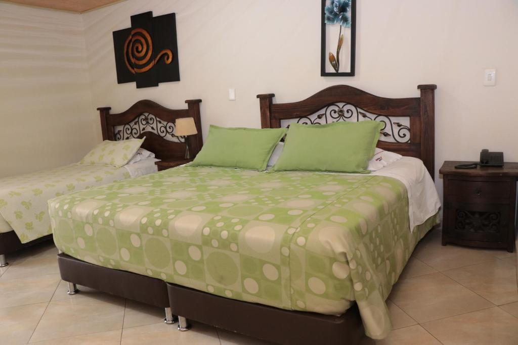 Postel nebo postele na pokoji v ubytování Hoteles Bogotá Inn Park Way