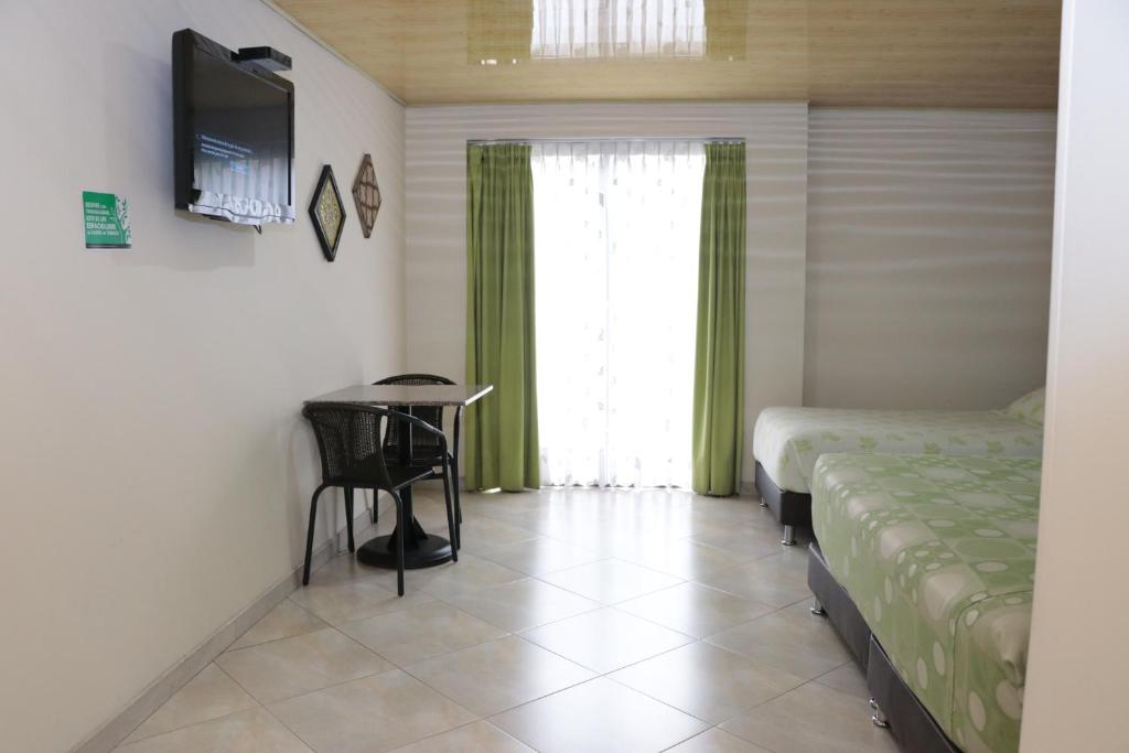 Postel nebo postele na pokoji v ubytování Hoteles Bogotá Inn Park Way