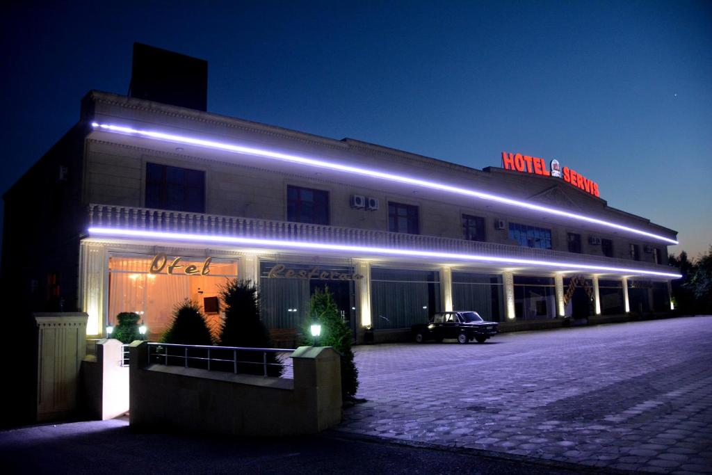 un edificio con luces azules en el lateral. en HII Hotel, en Sheki