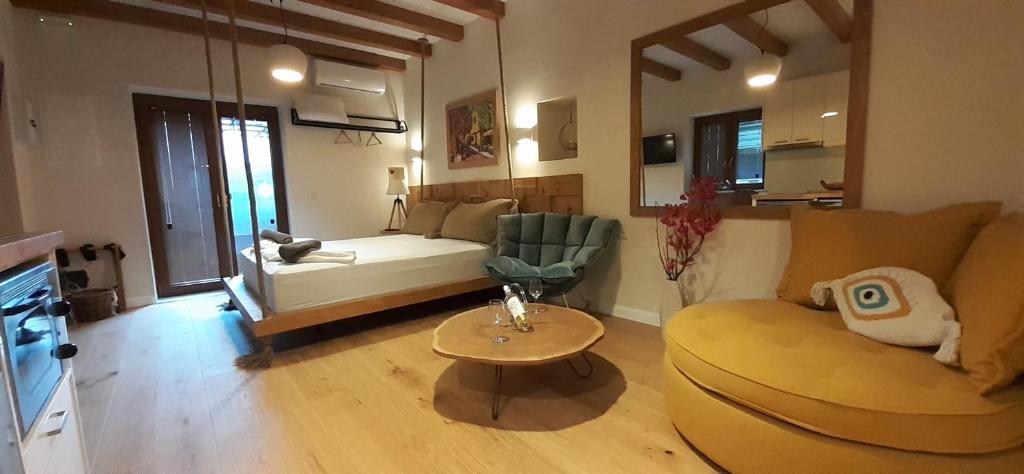 a living room with a couch and a table at Andros 4 All Seasons Villas & Suites in Andros