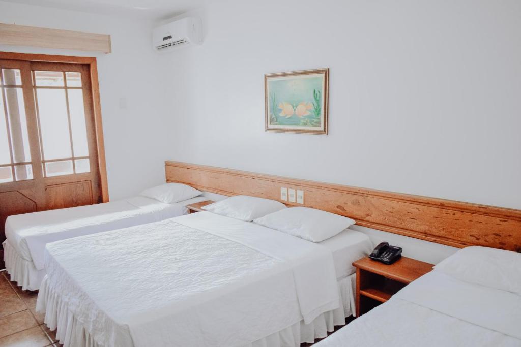 Postel nebo postele na pokoji v ubytování Poty Praia Hotel