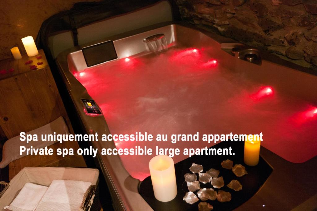 a hot tub with red lights in a bathroom at Chalet ZenArcs in Bourg-Saint-Maurice