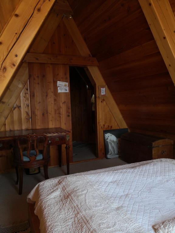 Postel nebo postele na pokoji v ubytování le chalet pointu de capucine