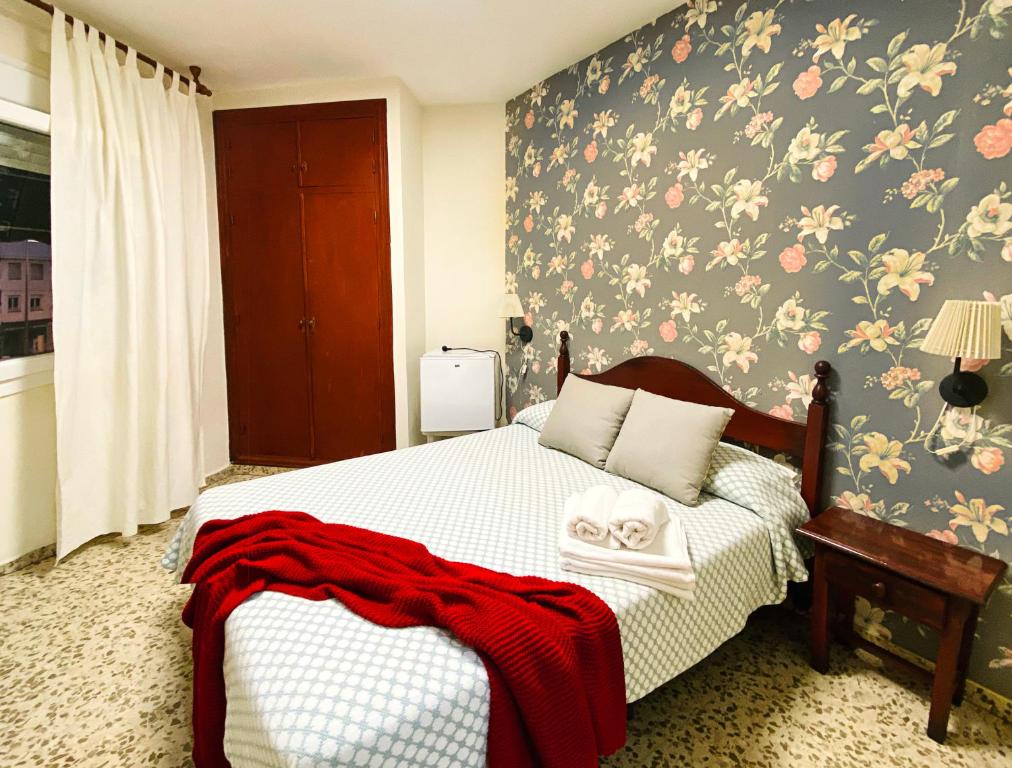 Postel nebo postele na pokoji v ubytování Hostal Azahara