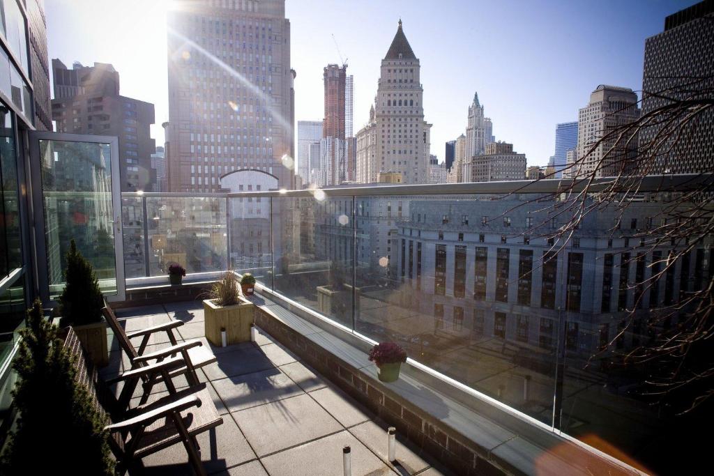 a building balcony with a view of a city at Hotel Mulberry in New York