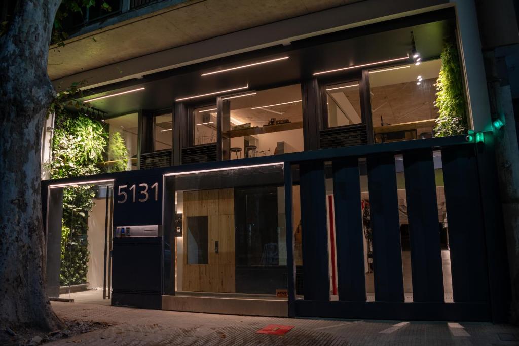 a building with the front door lit up at night at Grid Suites Charcas in Buenos Aires