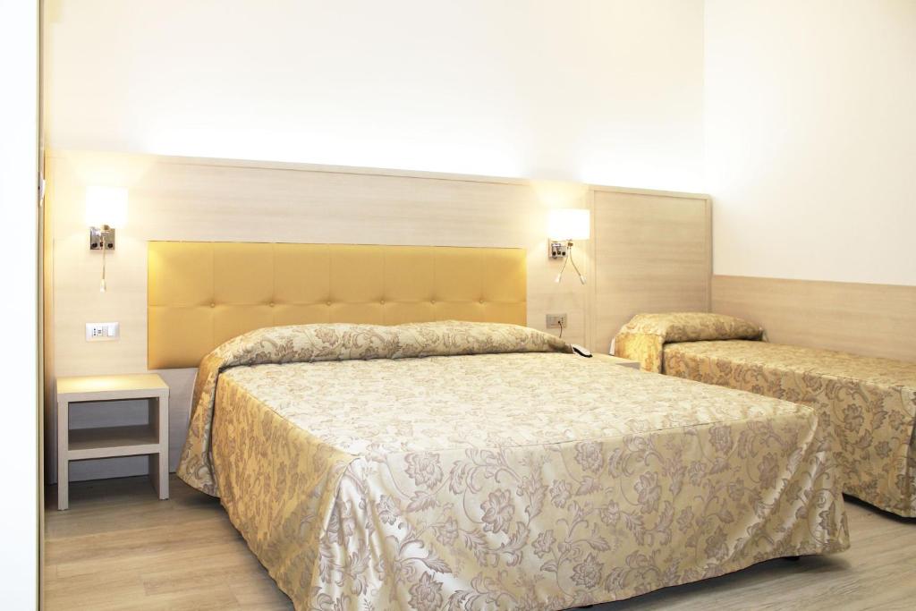 Postel nebo postele na pokoji v ubytování CSI Group - Hotel Metropoli