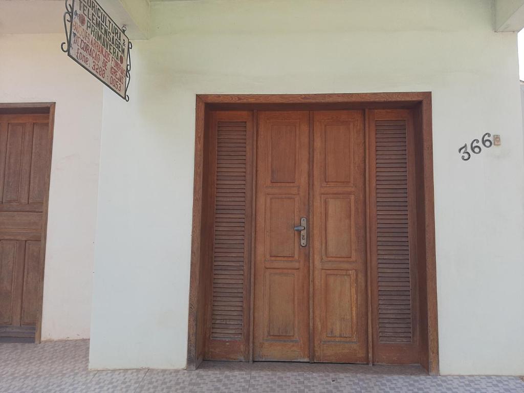 a wooden door on the side of a building at Apartamento Confortável in Marechal Floriano