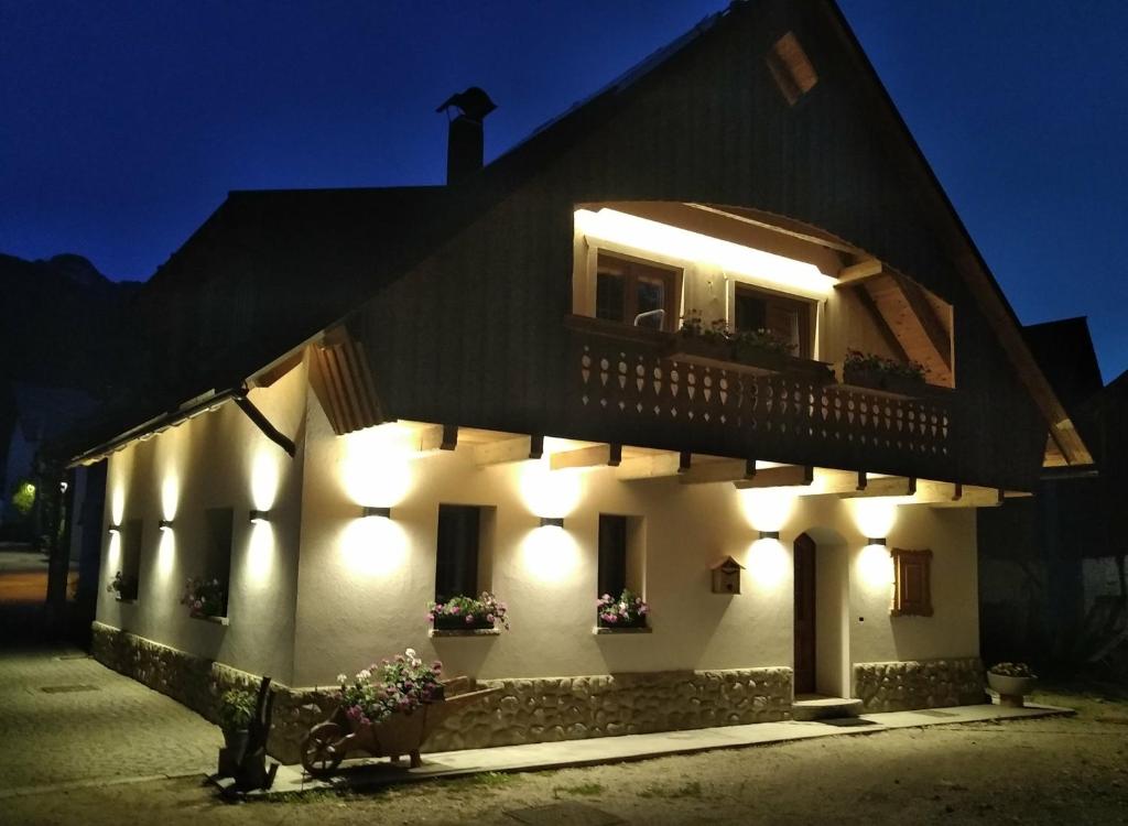 a building with lights on the side of it at night at Greuth Hutte in Tarvisio