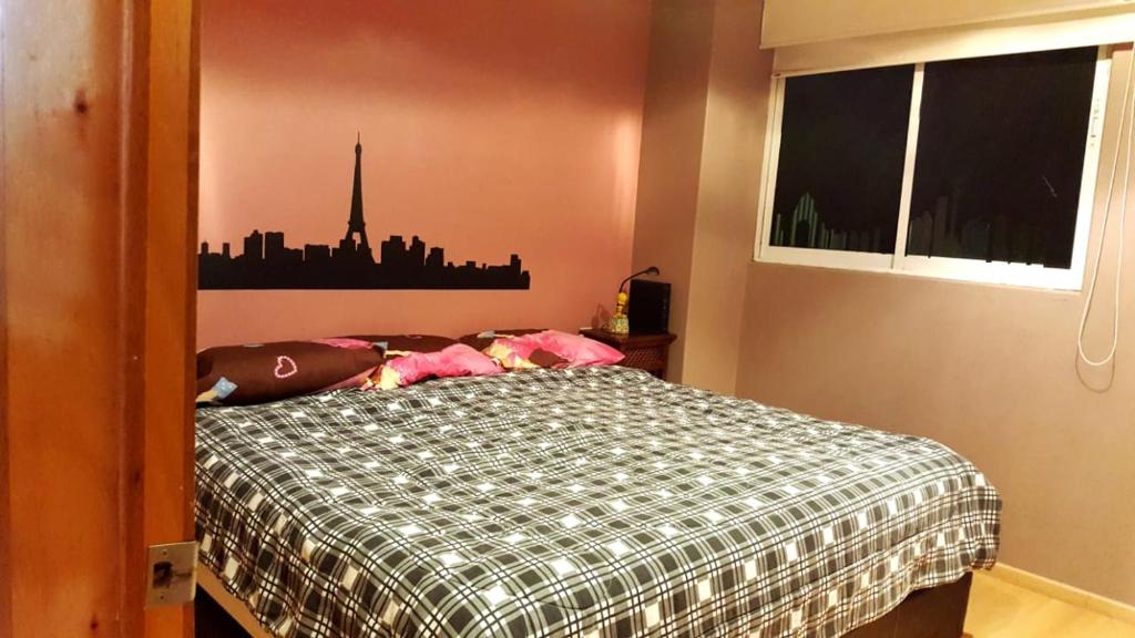 a bedroom with a bed with a city skyline on the wall at Castillo de Chapultepec in Mexico City