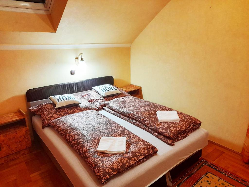 a bedroom with a bed with two pillows on it at Mátra Wellness Vendégház in Parádsasvár