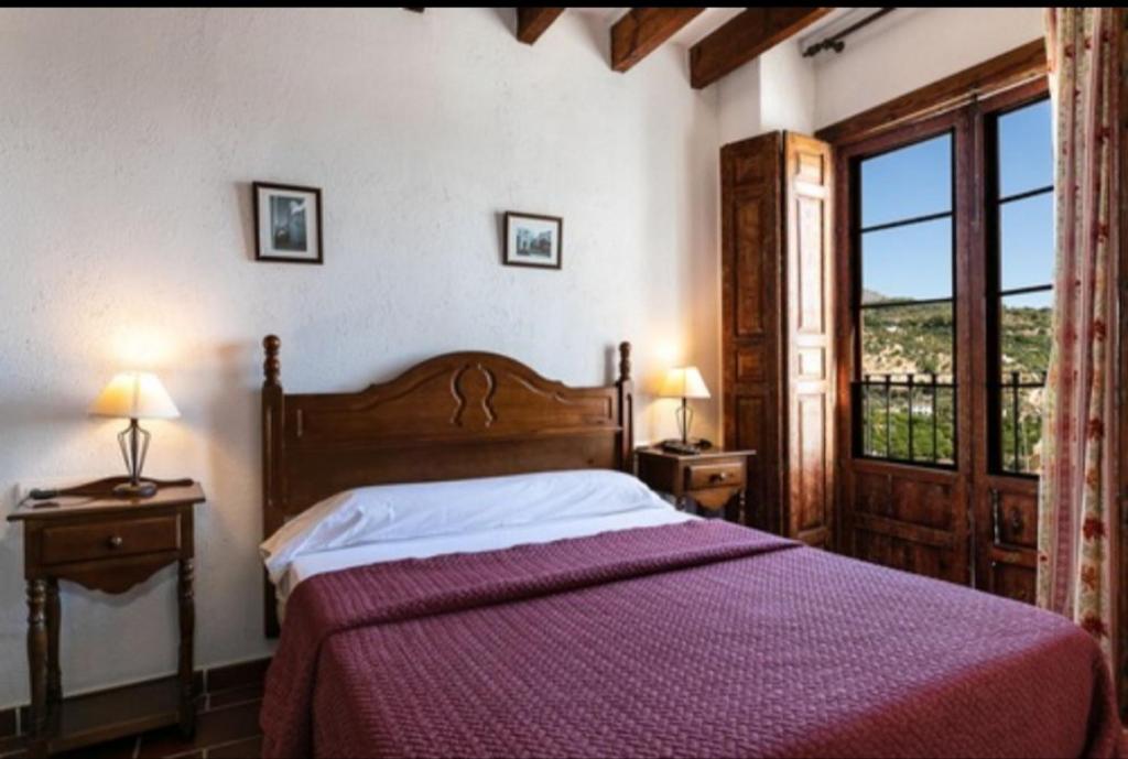 En eller flere senge i et værelse på Casa Rural Del Rio