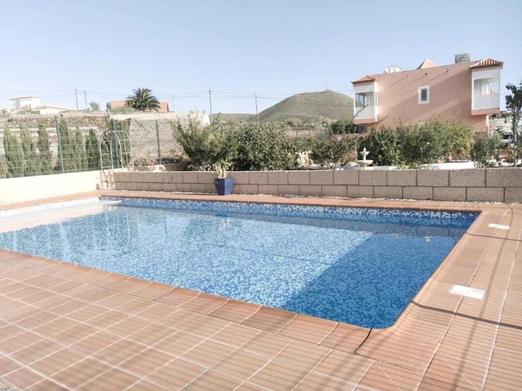 a swimming pool in front of a house at Casa Lansa in Granadilla de Abona