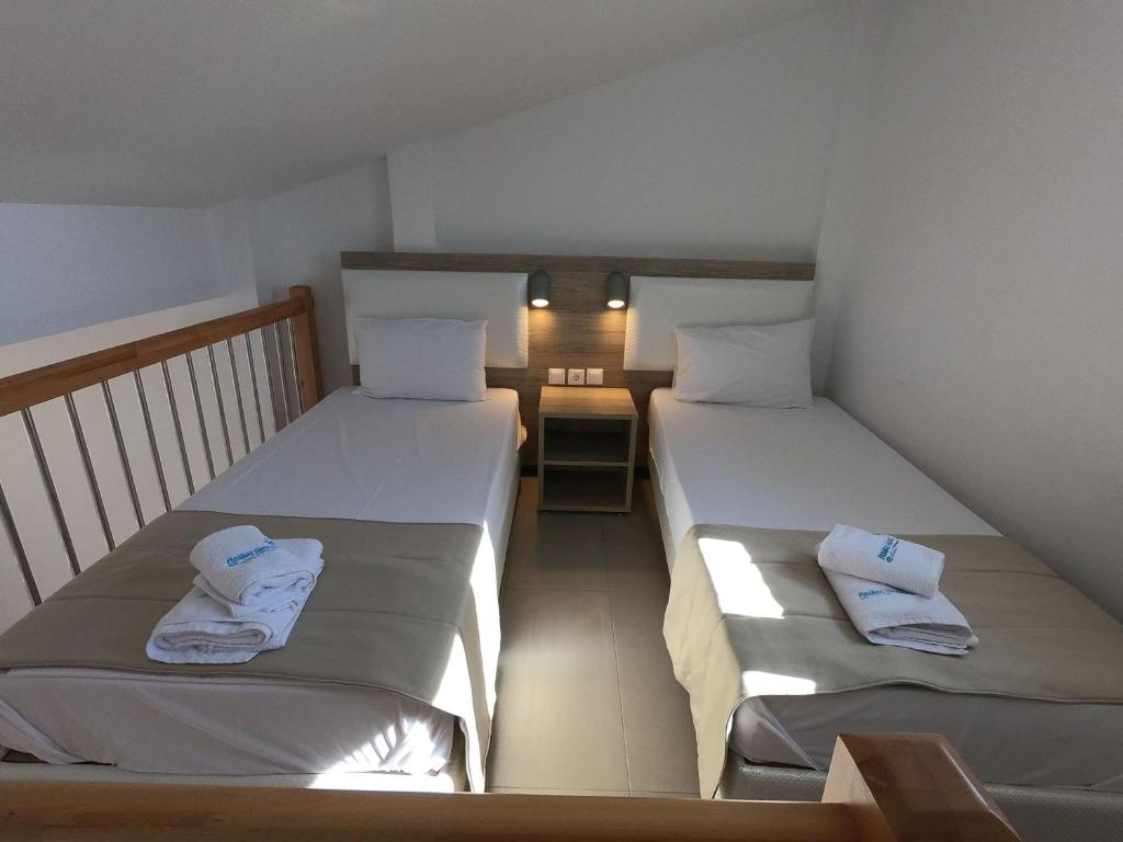 A bed or beds in a room at Finikas Garden Beach Resort Nikiti