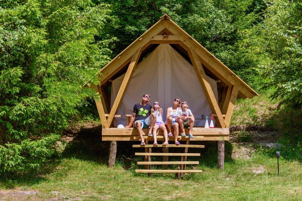 a group of three people sitting in front of a tent at Adrenaline Check Camping in Bovec