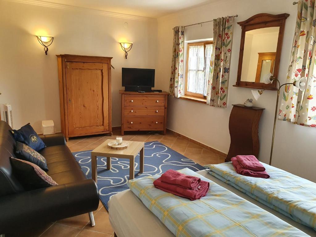 a living room with two beds and a couch at Landhaus Steirerengel - Ferien &amp; Jagd in Lócs