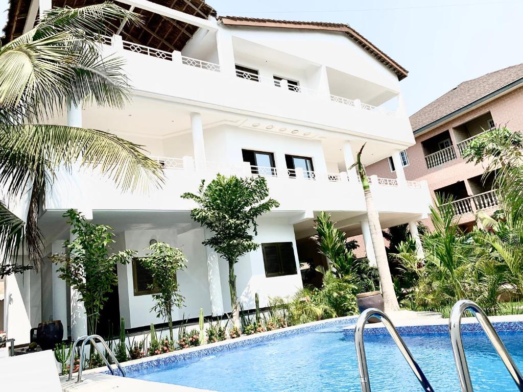 a villa with a swimming pool in front of a building at Villa Luxury Baguida in Lomé