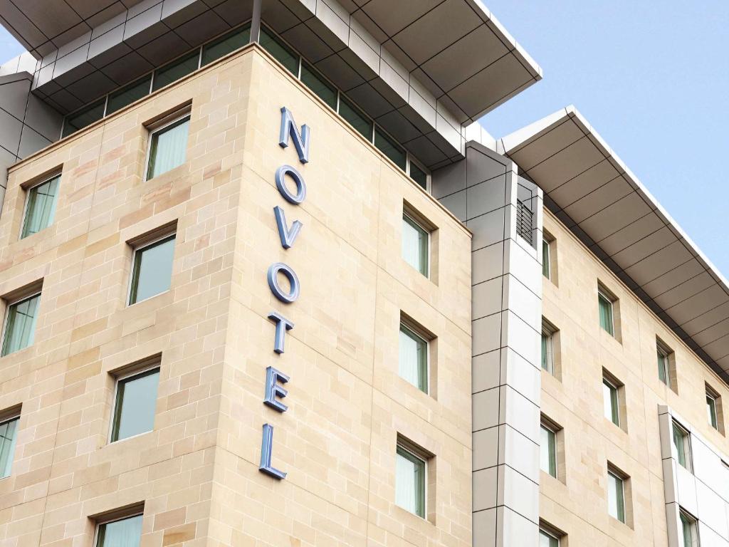 a large building with a sign on the side of it at Novotel Glasgow Centre in Glasgow